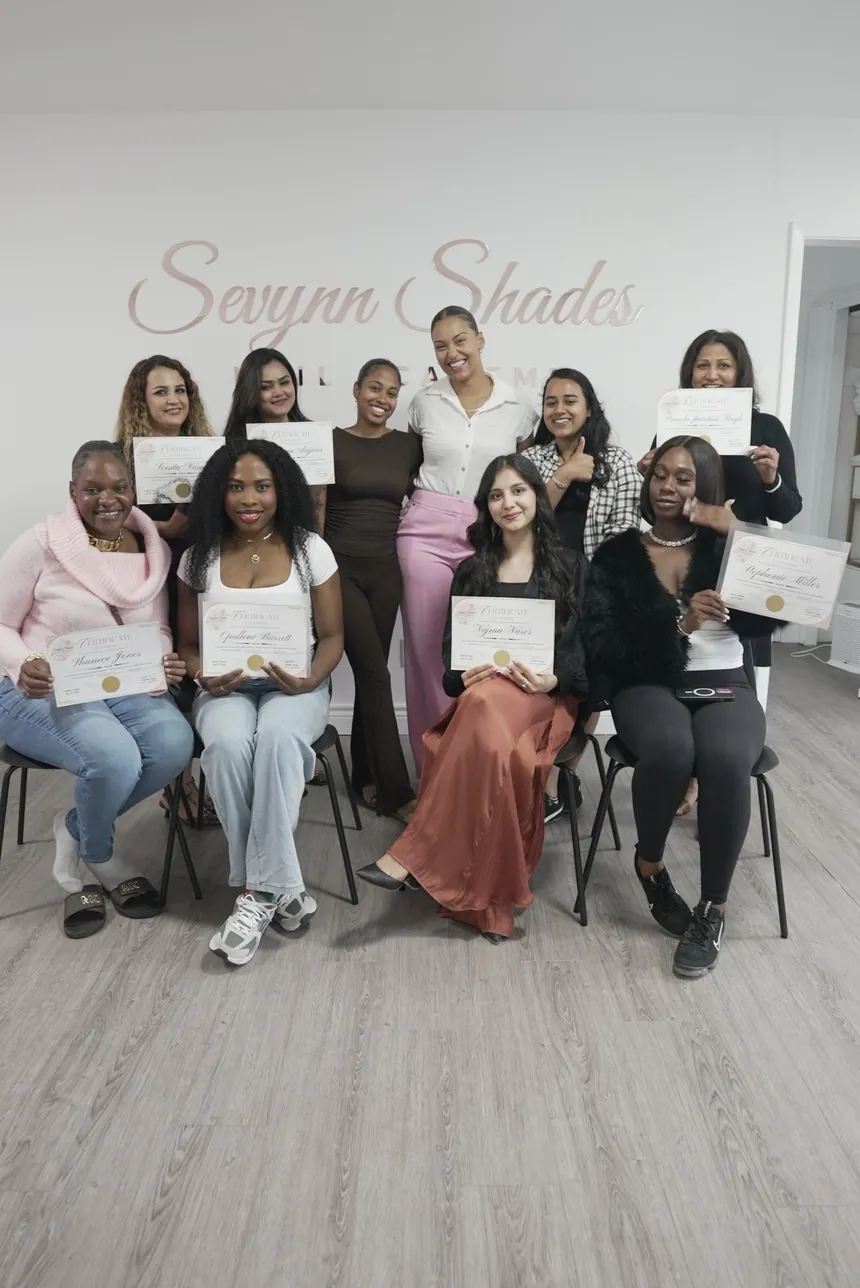 Graduates of Sevynn Shades Nail Academy holding their certificates